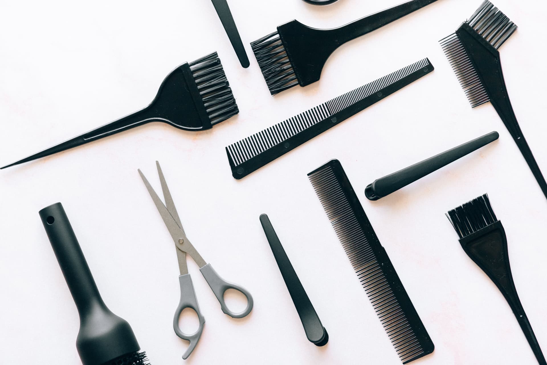 An assortment of hair styling tools laid out on a plain surface
