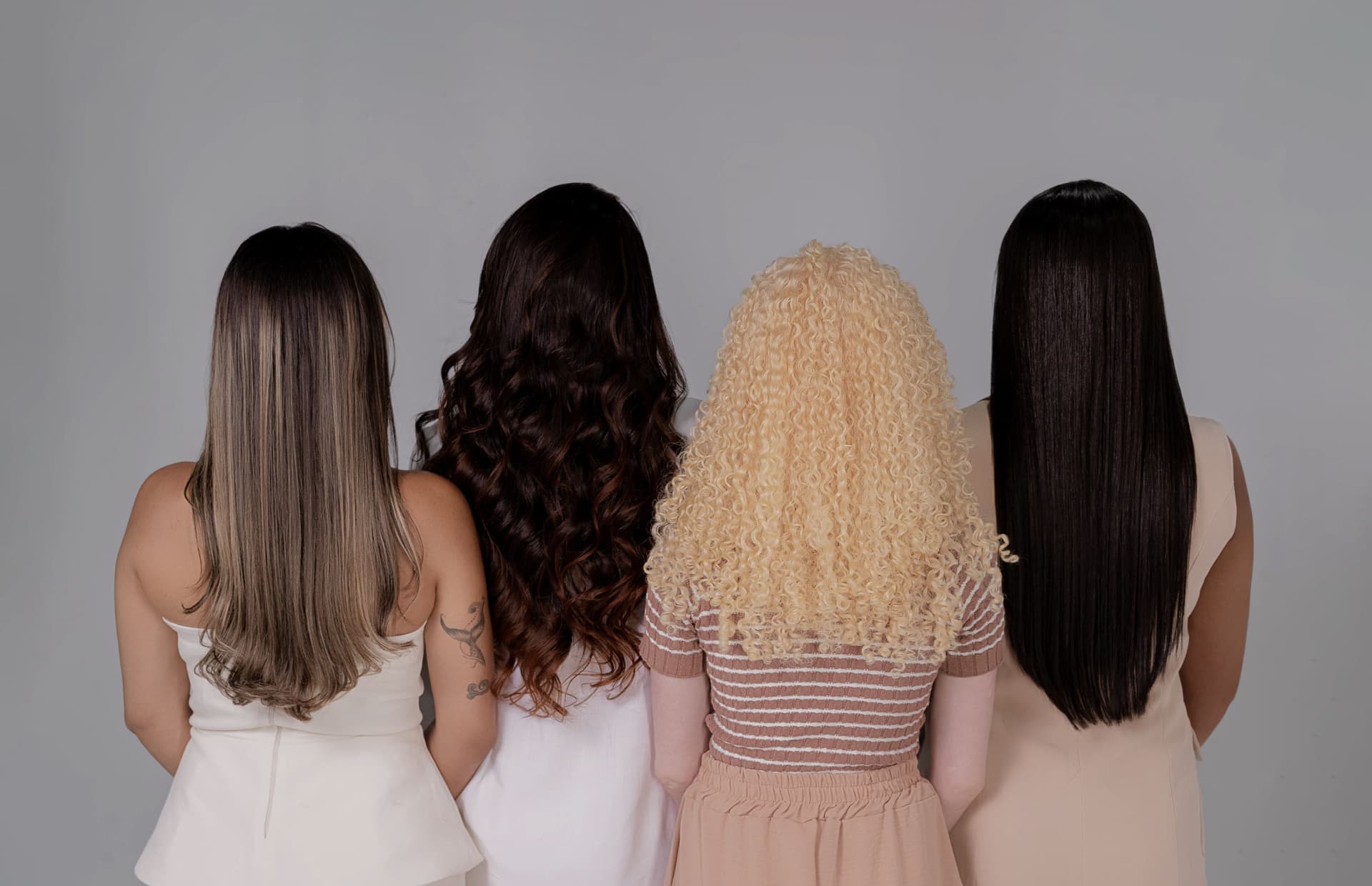 Three people with different hair textures photographed in natural light